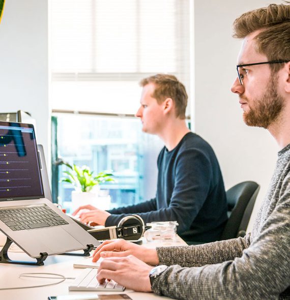 Software developers typing on  laptops